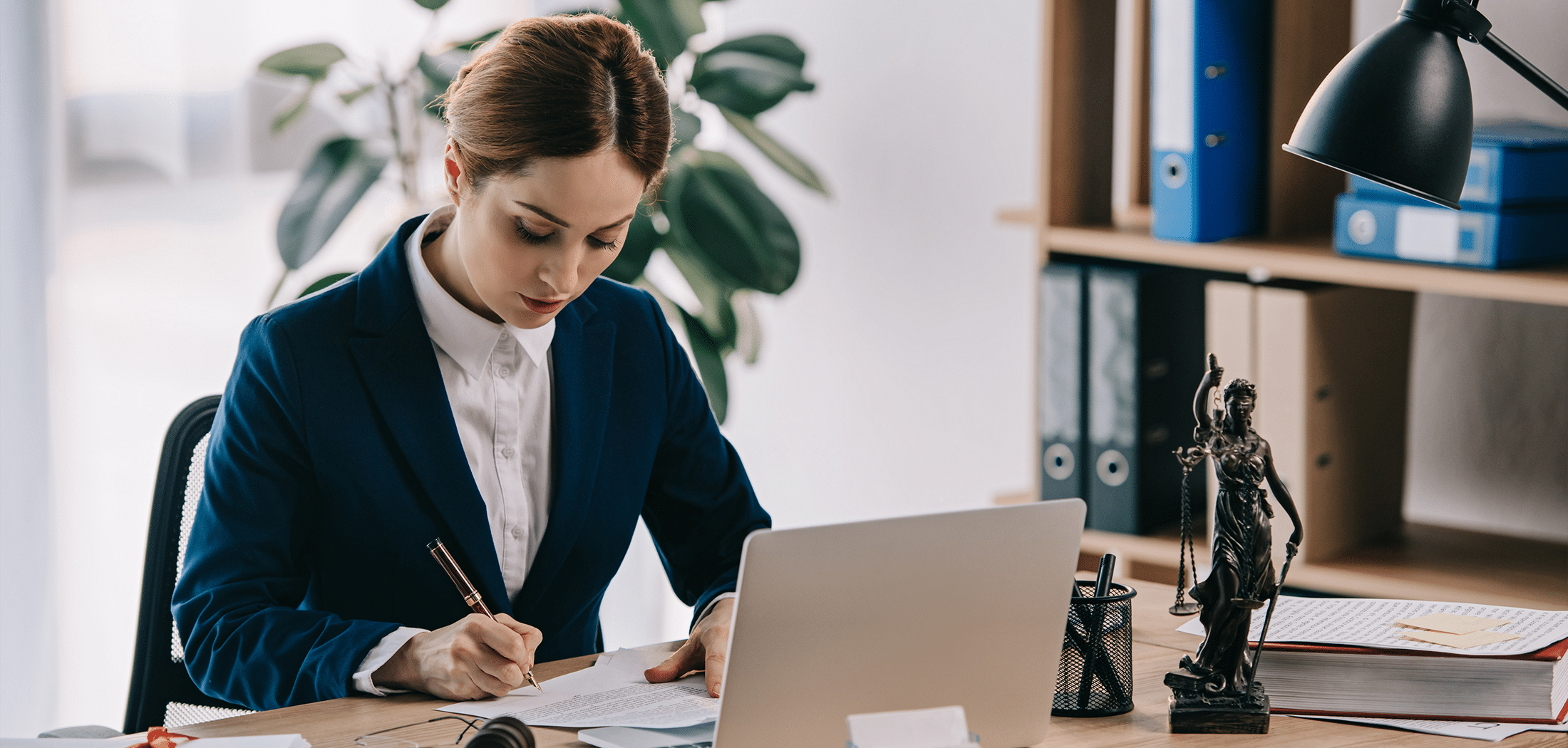 Female lawyer in a suit working on a client’s disability tax credit