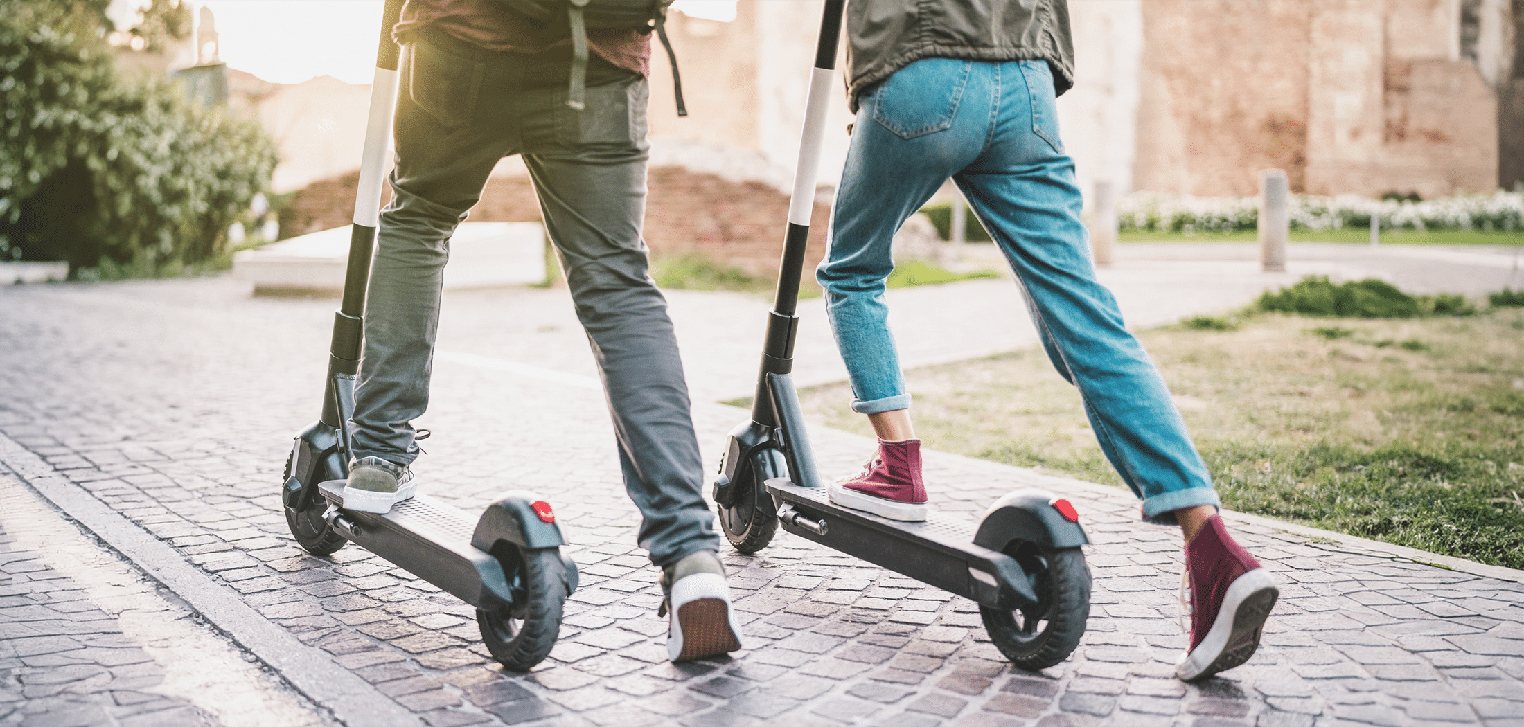 Couple using electric scooter in Toronto