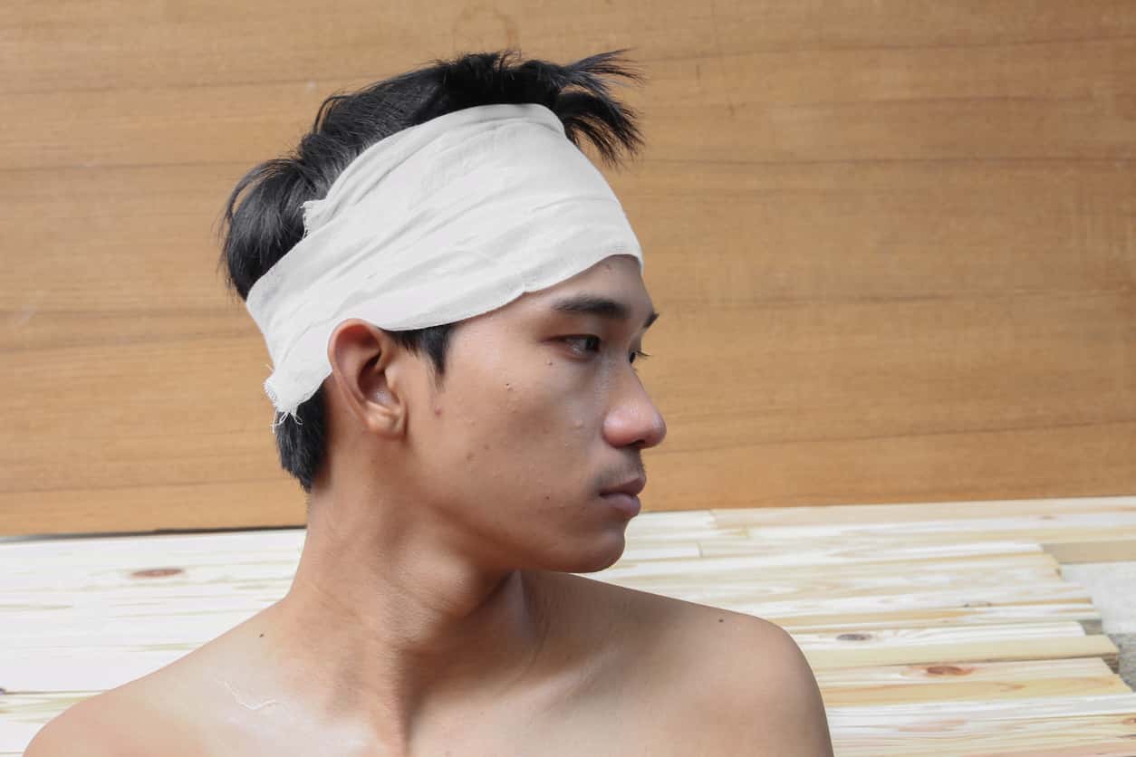 Young man with trauma of the head. by Medical bandage