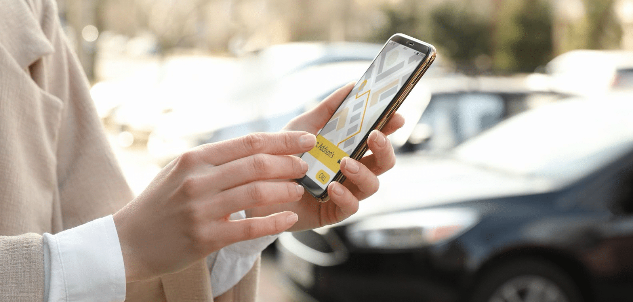 Woman ordering taxi with smartphone on city street, closeup