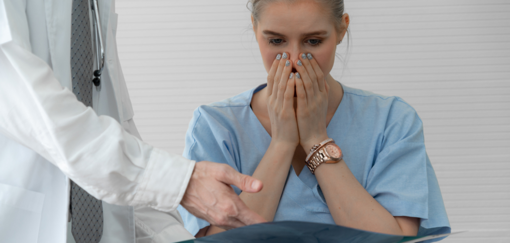 Medical Patient with hands over mouth