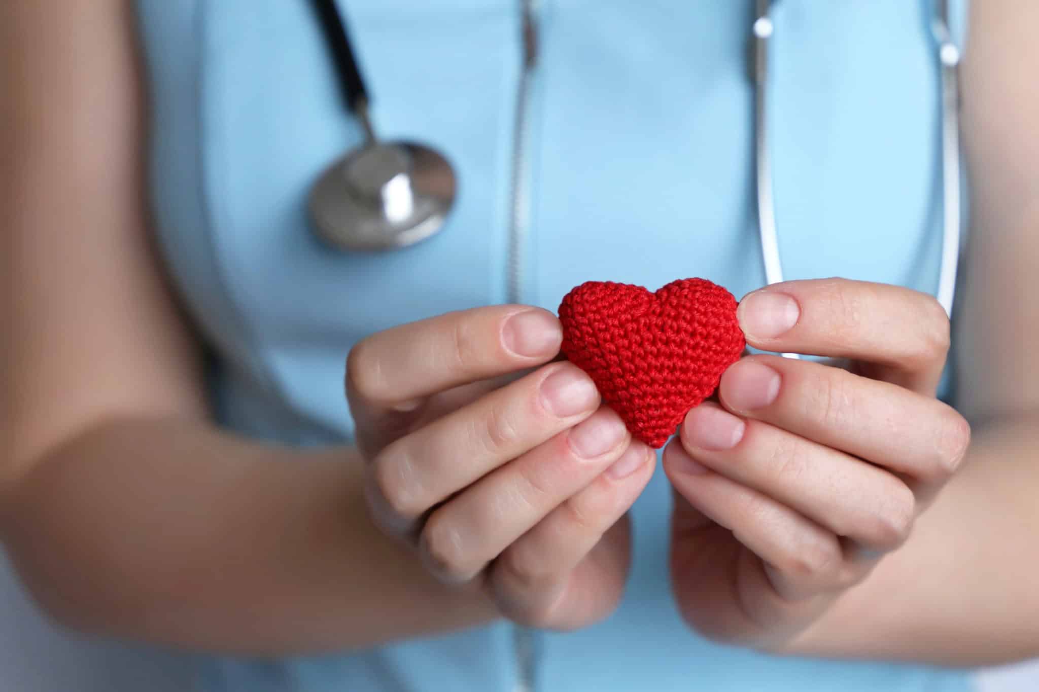Nurse holding a heart