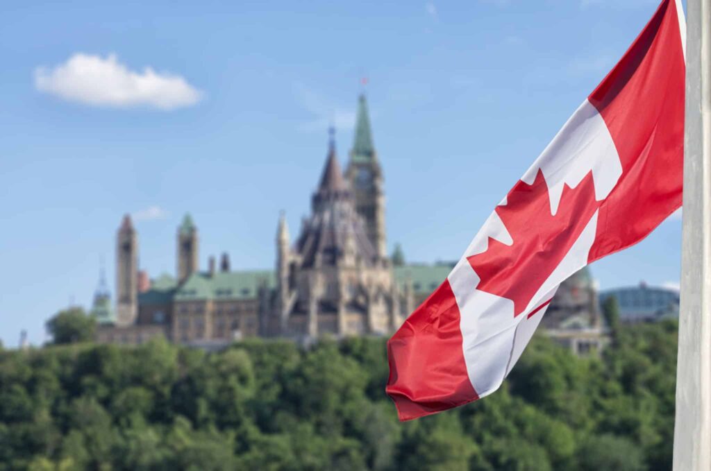 Canadian flag against parliament backdrop