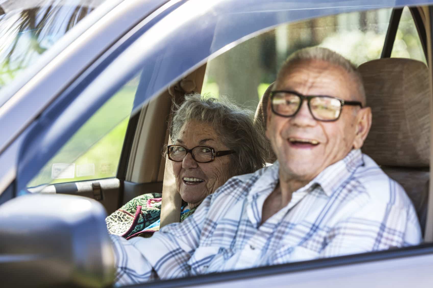Senior Couple Grinning In Car