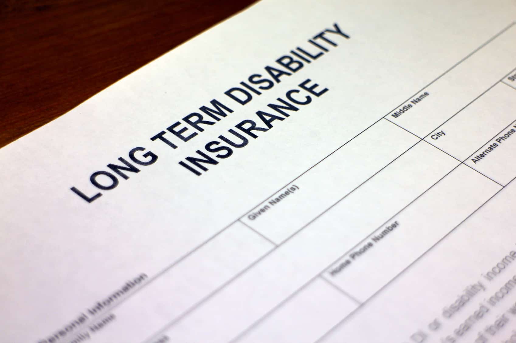 Someone filling out Long term Disability Insurance Application Form.