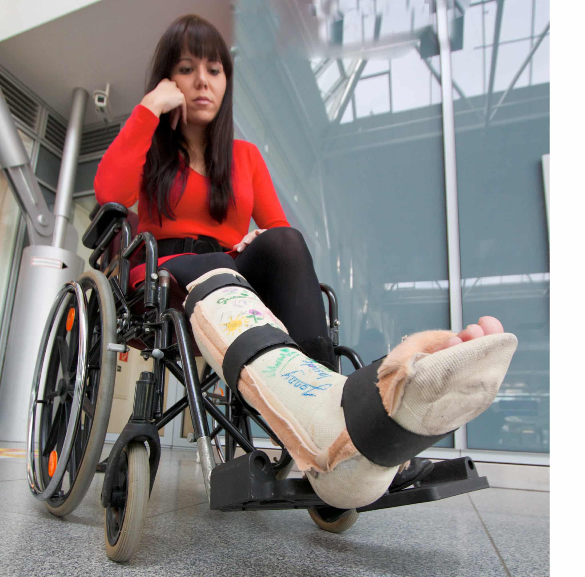 woman with leg cast in wheelchair